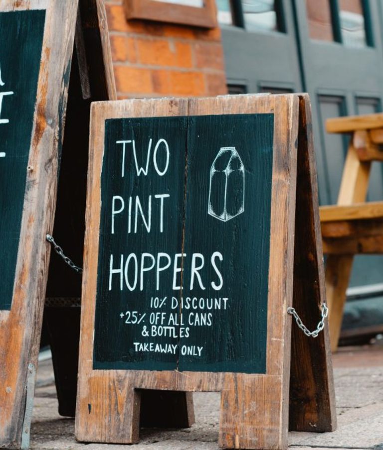 Sandwich board with drinks off on it